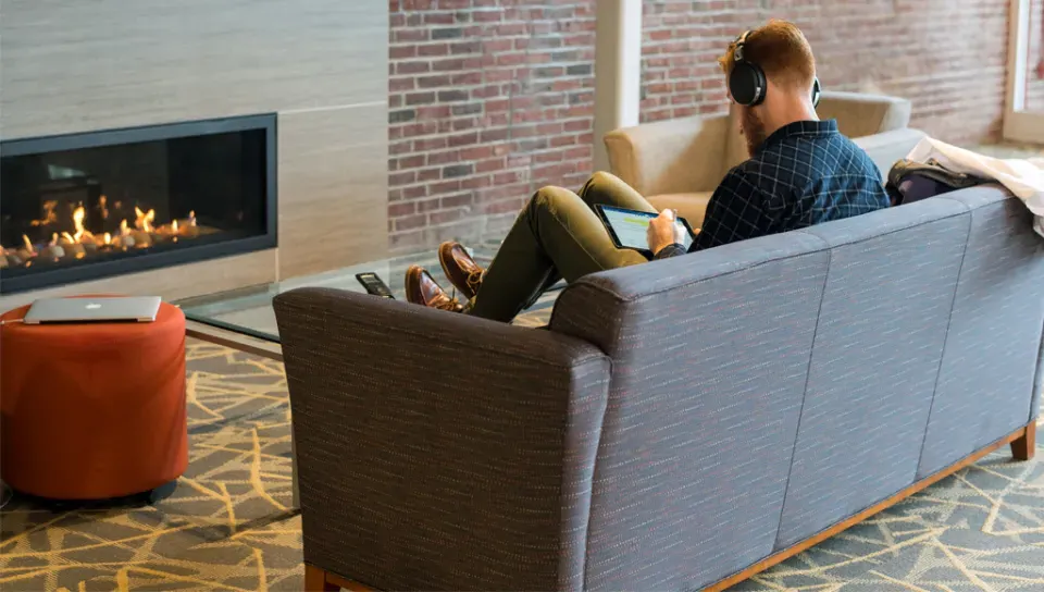 A student studies in front of a fireplace